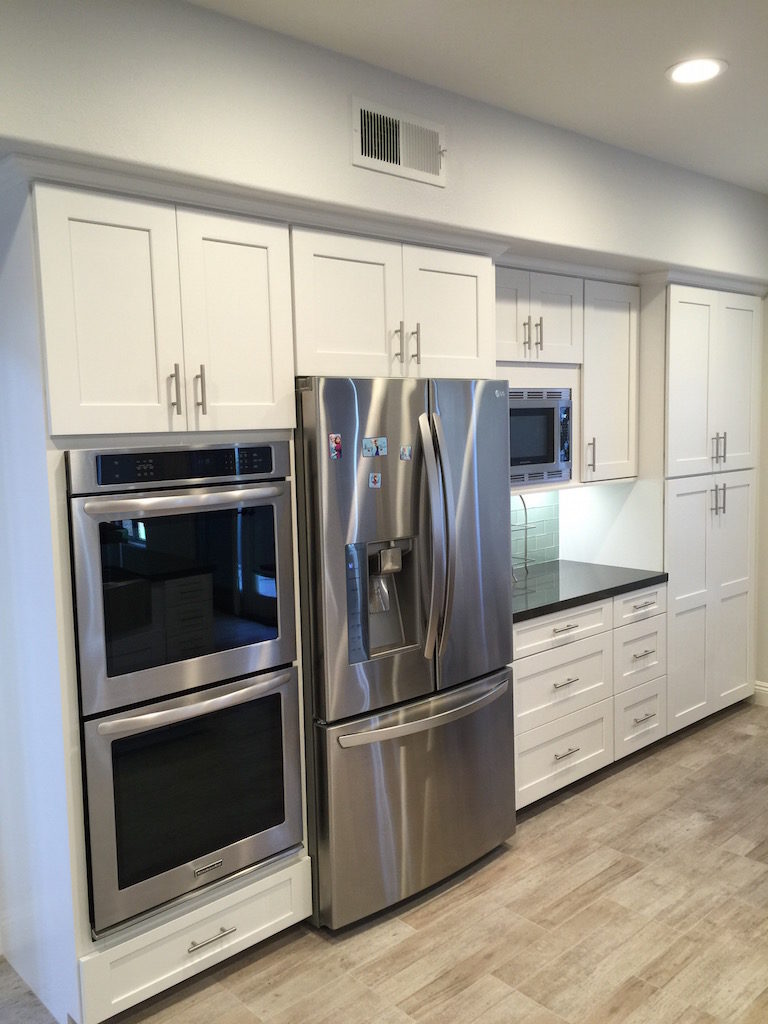 kitchen renovation contractor uses space under double oven for storage