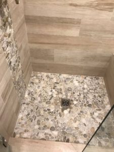 shower remodel uses tile that looks like wood