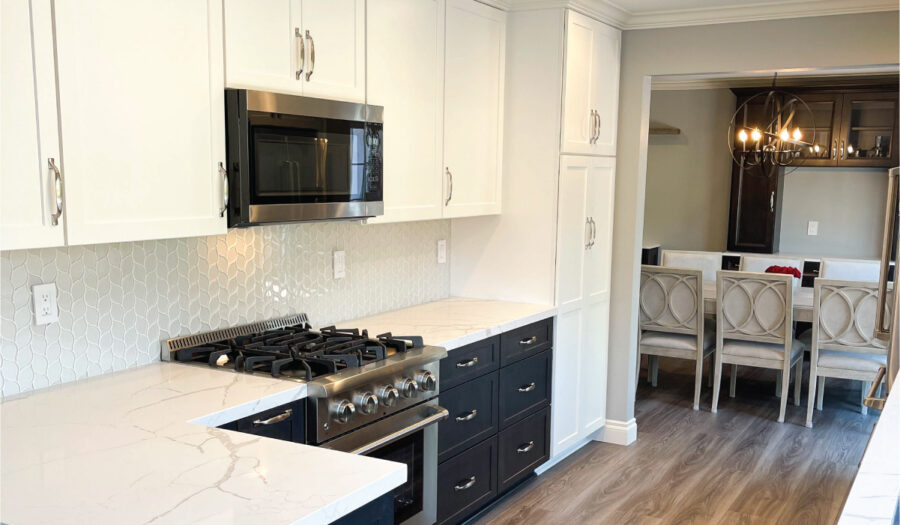 Black and white kitchen cabinetry with wood look flooring