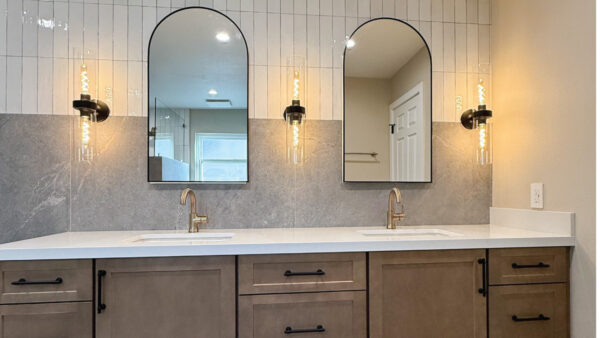 Master bathroom retreat with warm wood tones, arched mirrors, and a combo of subway tile and large format tile to create height.